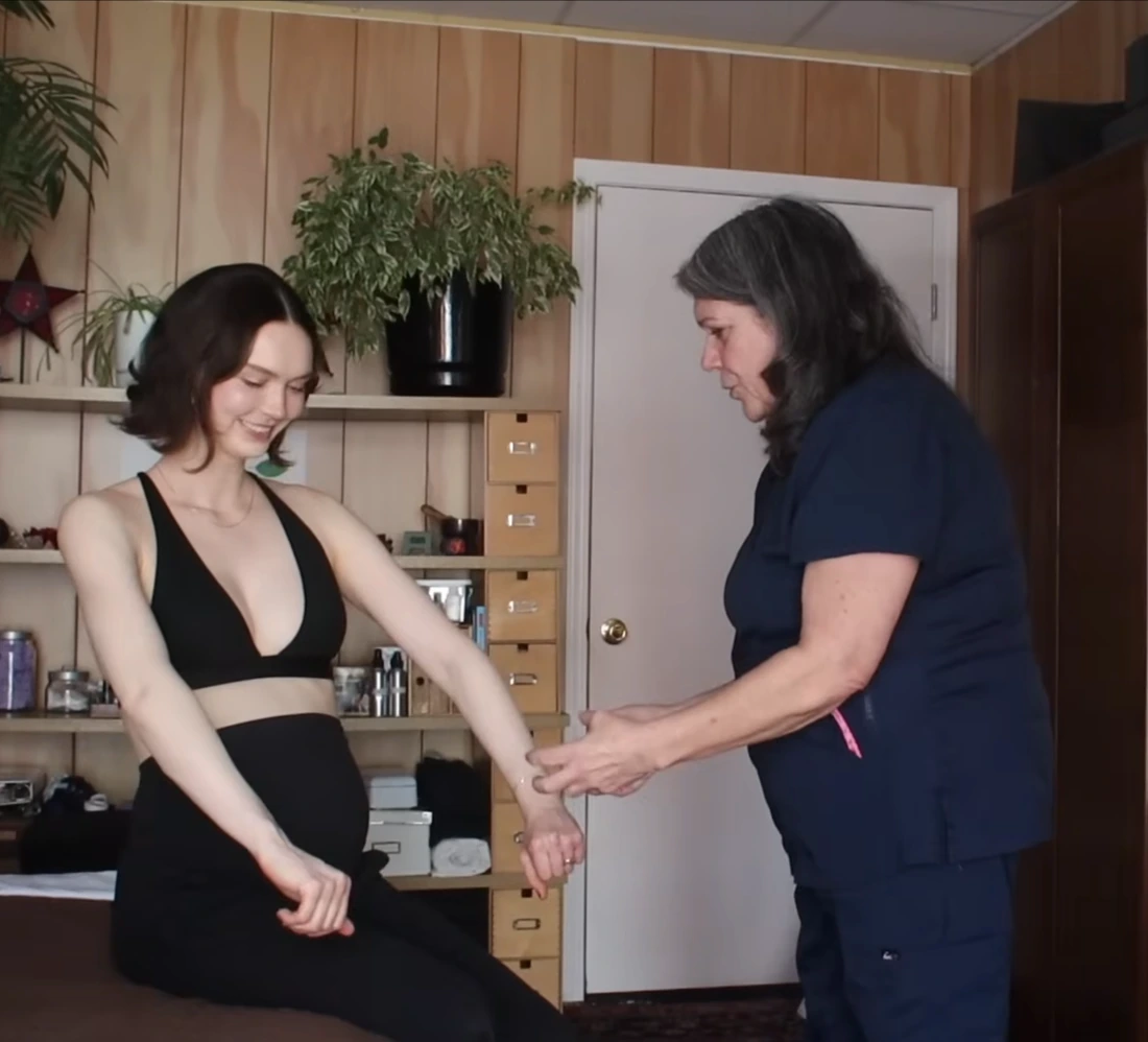 A practitioner using gentle hands-on technique during a treatment